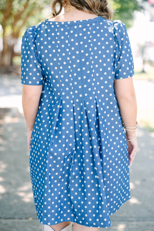 Plus Size navy blue short sleeve dress with white polka dots and a split v-neckline.