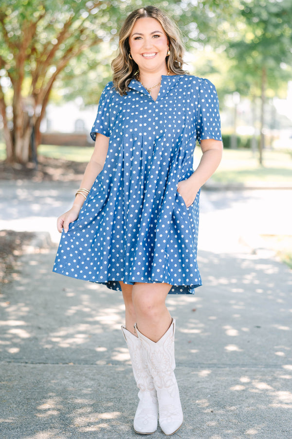 Plus Size navy blue short sleeve dress with white polka dots and a split v-neckline.