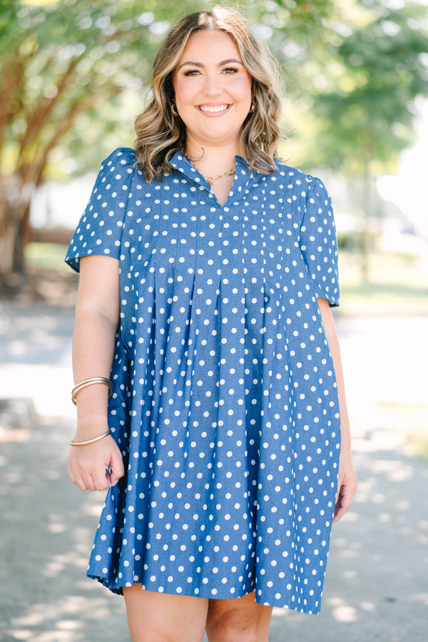 Plus Size navy blue short sleeve dress with white polka dots and a split v-neckline.