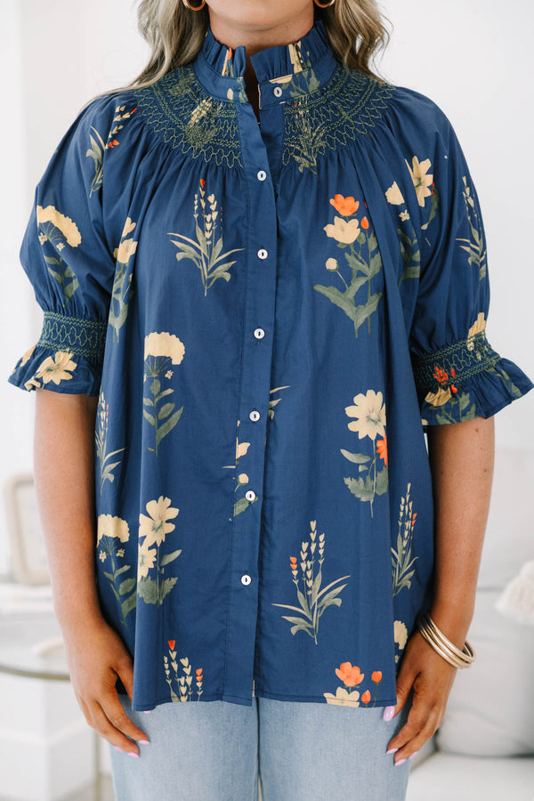 Plus size navy floral cotton top with smocked high neck, button front, and flowy puff sleeves.