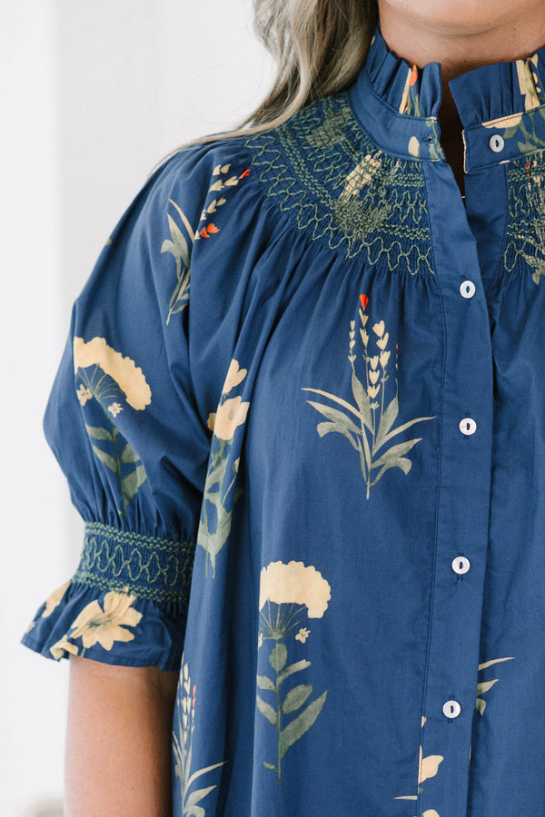 Plus size navy floral cotton top with smocked high neck, button front, and flowy puff sleeves.