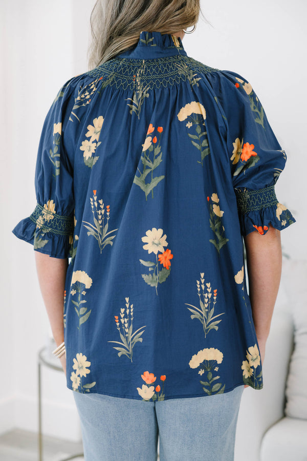 Plus size navy floral cotton top with smocked high neck, button front, and flowy puff sleeves.