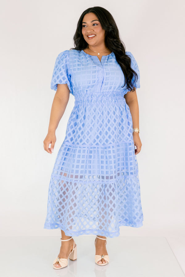 Chic Soul plus size clothing, pastel blue maxi dress with buttons going down to the chest and bubble sleeves as well as a sheer overlay going over the whole dress that has a plaid pattern 