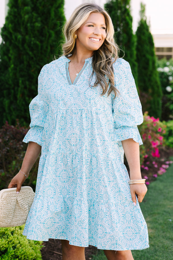 Chic Soul plus size clothing, teal knee length dress with half sleeves that have a ruffle flare out on the ends as well as a v-neckline circle abstract pattern throughout 
