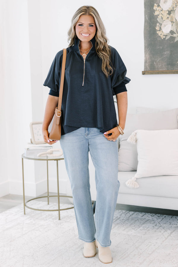 Plus size navy blue half-zip top with a flowy fit, short sleeves, and a gold zipper detail.