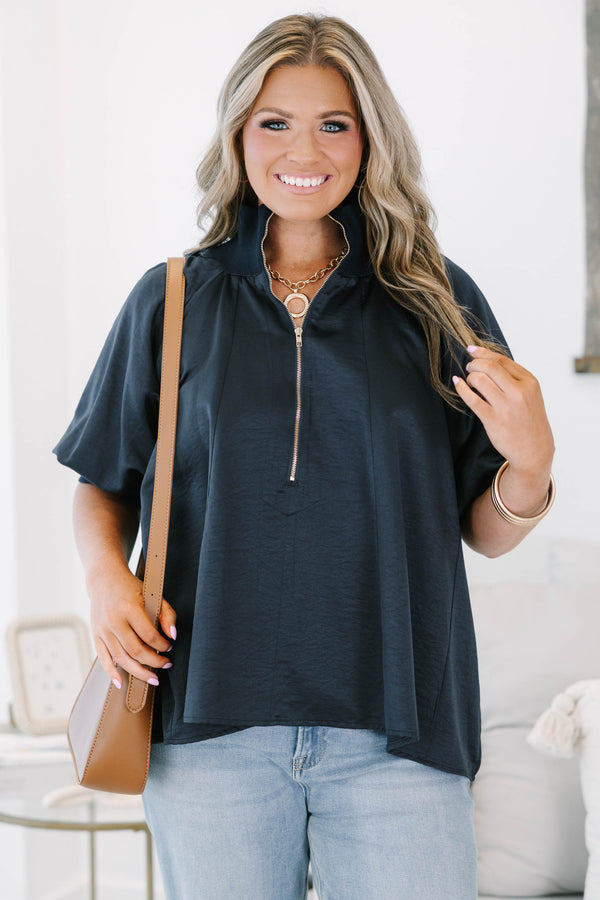 Plus size navy blue half-zip top with a flowy fit, short sleeves, and a gold zipper detail.