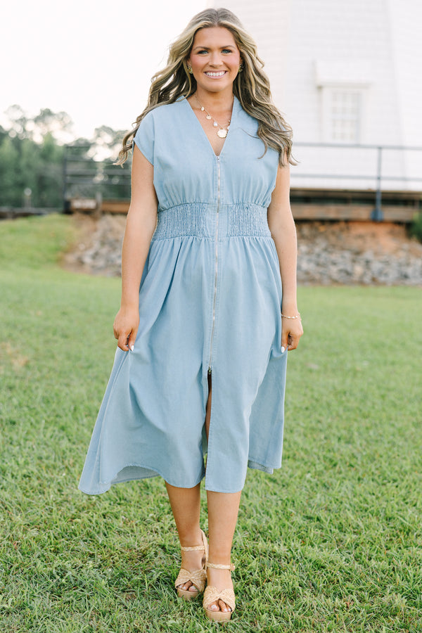 Plus Size light wash denim midi dress with a zip-front, V-neckline, and smocked waist.