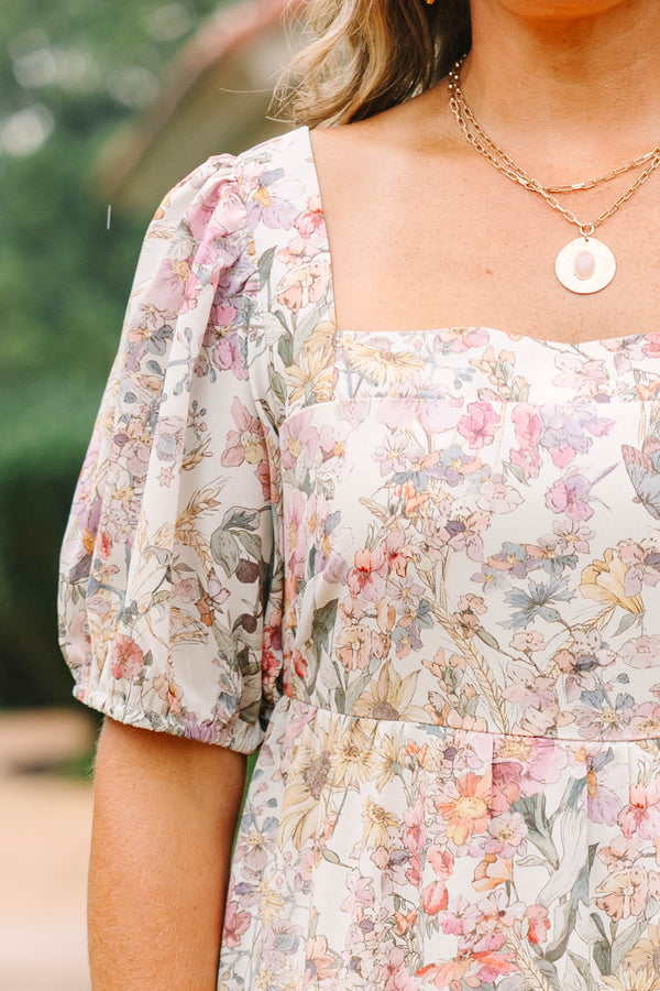Plus Size pink floral tiered maxi dress with a square neckline and short puff sleeves.