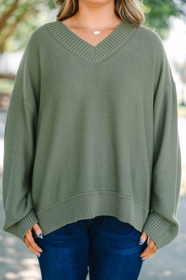 Plus Size olive green v-neck sweater with a relaxed fit, ribbed trim, and long drop-shoulder sleeves.
