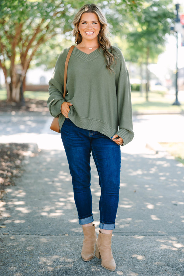 Plus Size olive green v-neck sweater with a relaxed fit, ribbed trim, and long drop-shoulder sleeves.