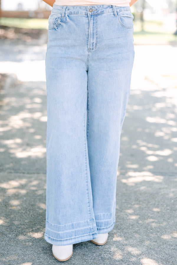 Plus Size light wash wide-leg jeans with a relaxed fit and wide stitched hem detail.