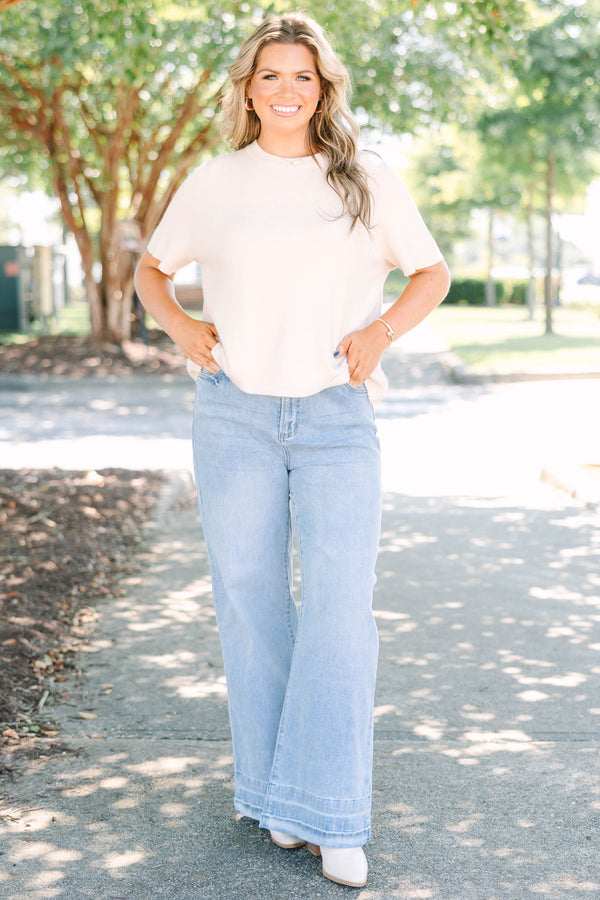 Plus Size light wash wide-leg jeans with a relaxed fit and wide stitched hem detail.