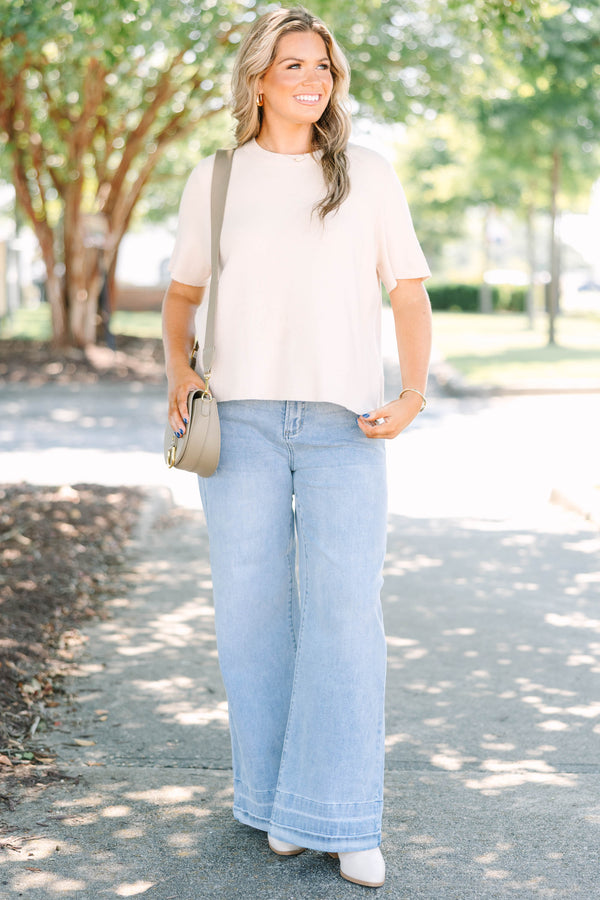 Plus Size light wash wide-leg jeans with a relaxed fit and wide stitched hem detail.