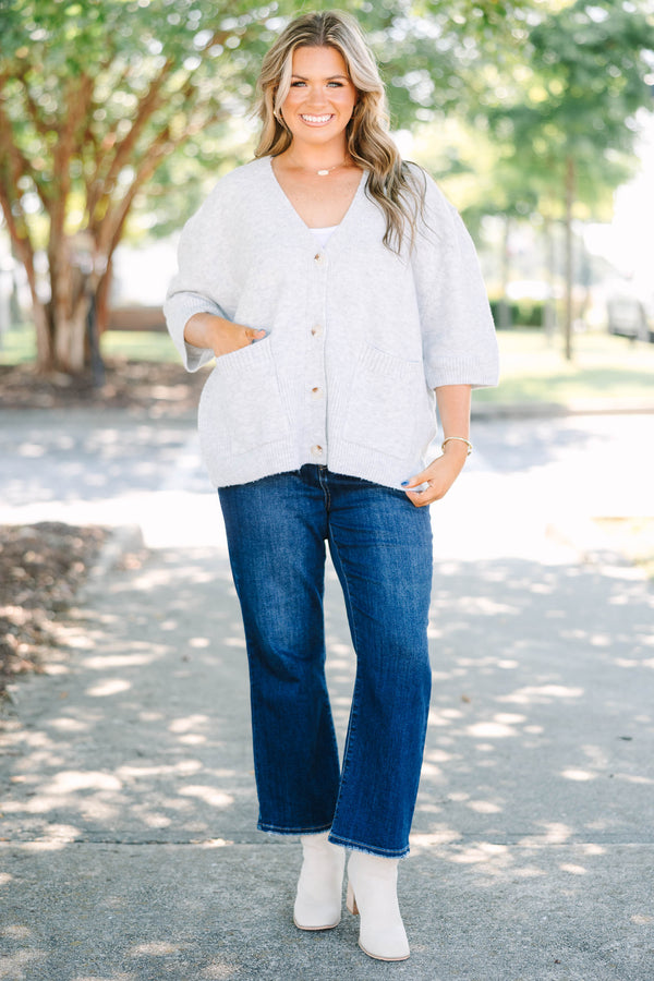 Plus Size gray v-neck cardigan with short sleeves, front patch pockets, and tortoise shell buttons.