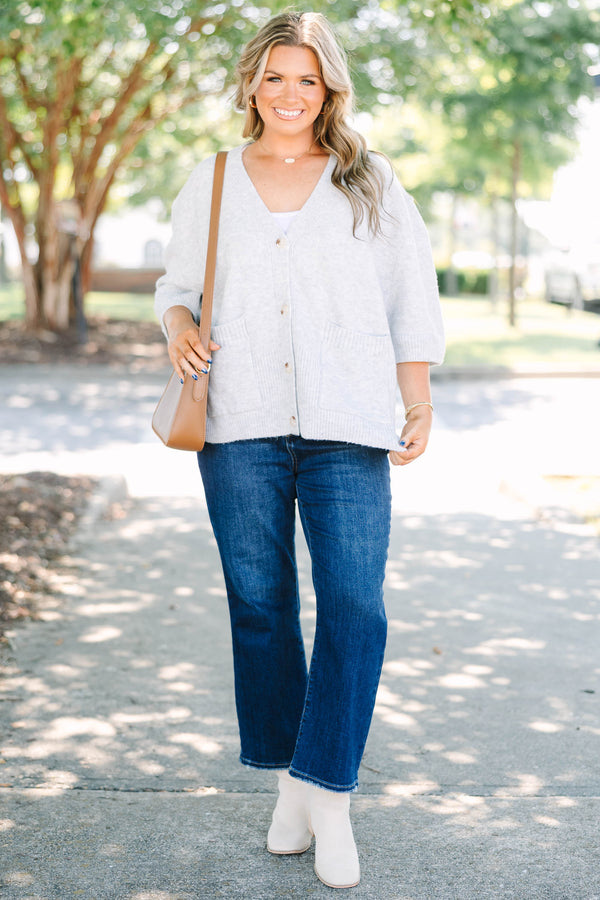 Plus Size gray v-neck cardigan with short sleeves, front patch pockets, and tortoise shell buttons.