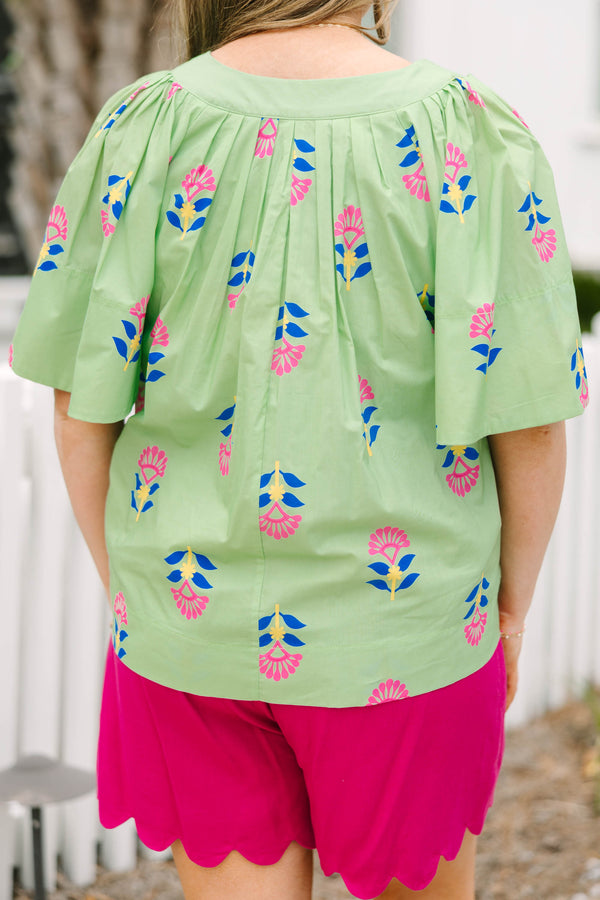 Chic Soul plus size clothing, green flutter short sleeve top with pink, blue, and yellow abstract floral pattern and v-neckline