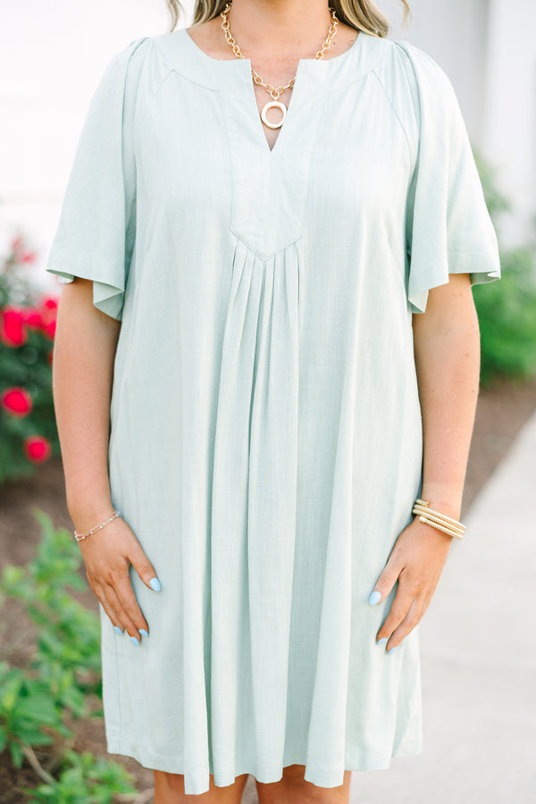Plus Size sage green short-sleeve dress with a V-neckline and pleated front detailing.