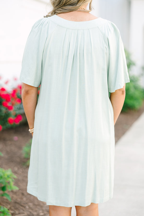 Plus Size sage green short-sleeve dress with a V-neckline and pleated front detailing.