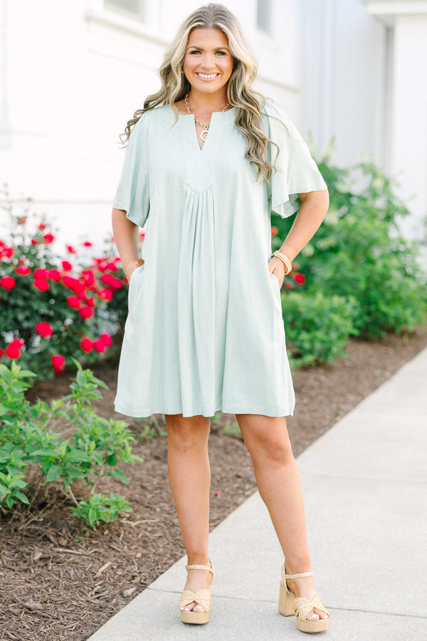 Plus Size sage green short-sleeve dress with a V-neckline and pleated front detailing.