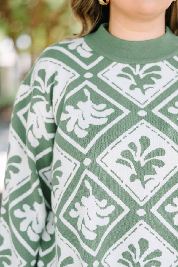 Plus Size green mock-neck sweater with a white diamond and floral-abstract print and wide sleeves.