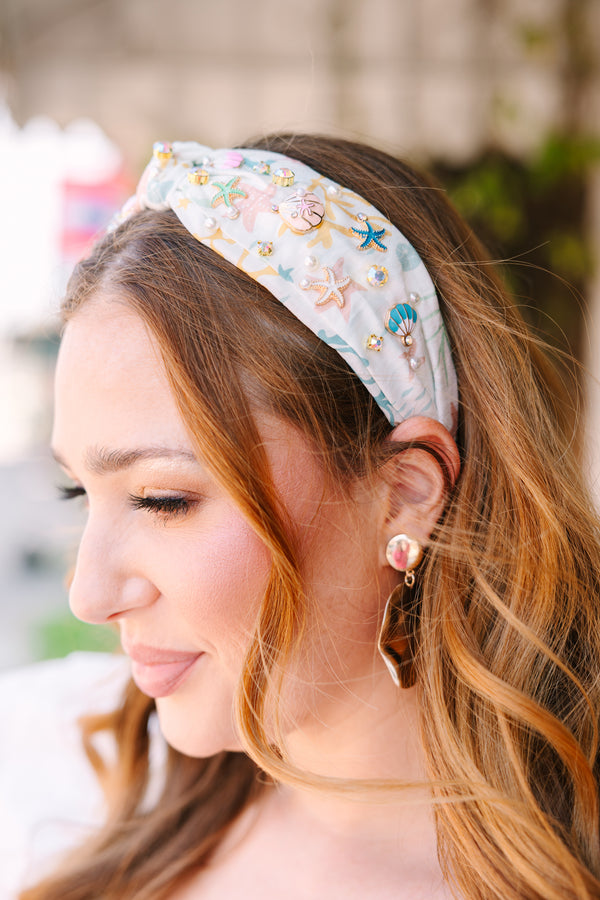 Chic Soul plus size clothing, white headband with a blue wave pattern as well as a knot look on the center of the headband and beach charms throughout 