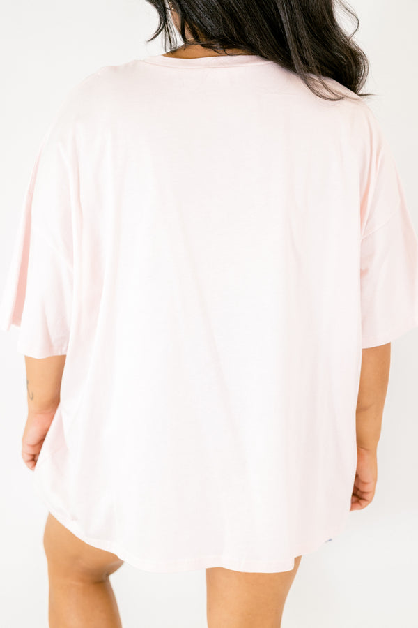 Chic Soul plus size clothing, Cream pink short sleeve graphic tee featuring a white bow graphic centered on the chest, filled with black polka dots and outlined in a darker pink 
