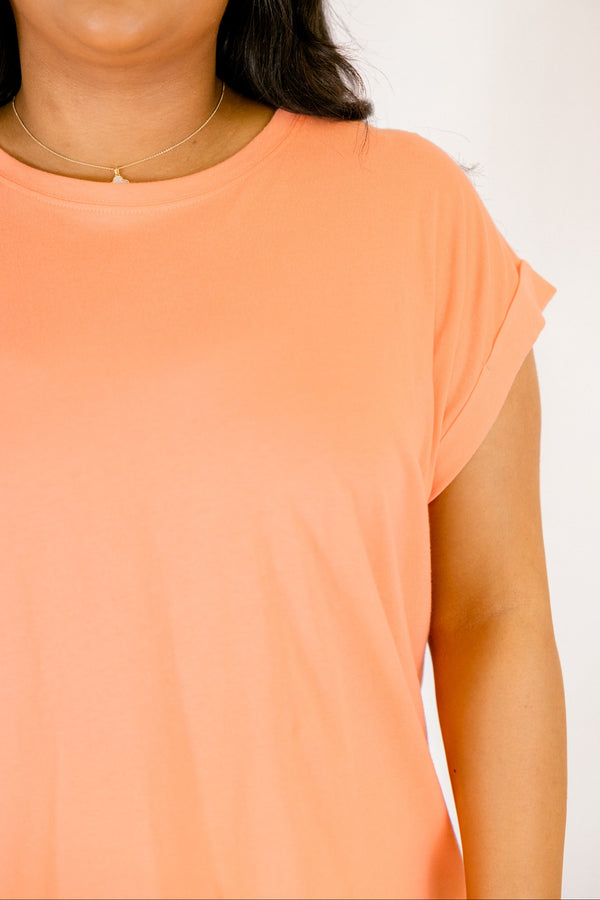 coral tee with cuffed short sleeves and a round neckline