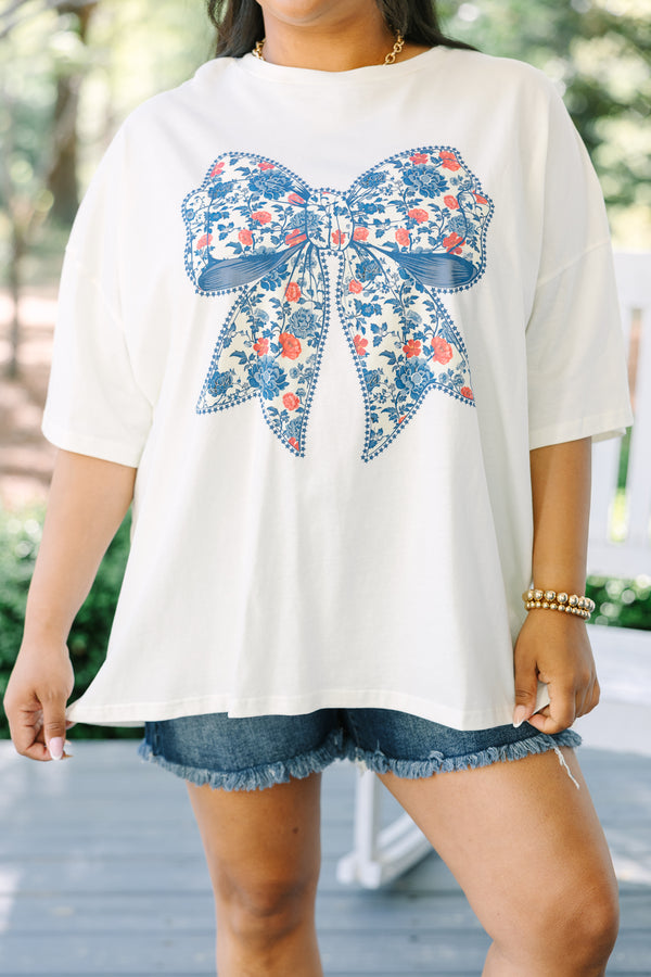 Chic Soul plus size clothing, ivory short sleeve graphic tee with a blue bow graphic in the center and a red and blue floral pattern filling the bow 