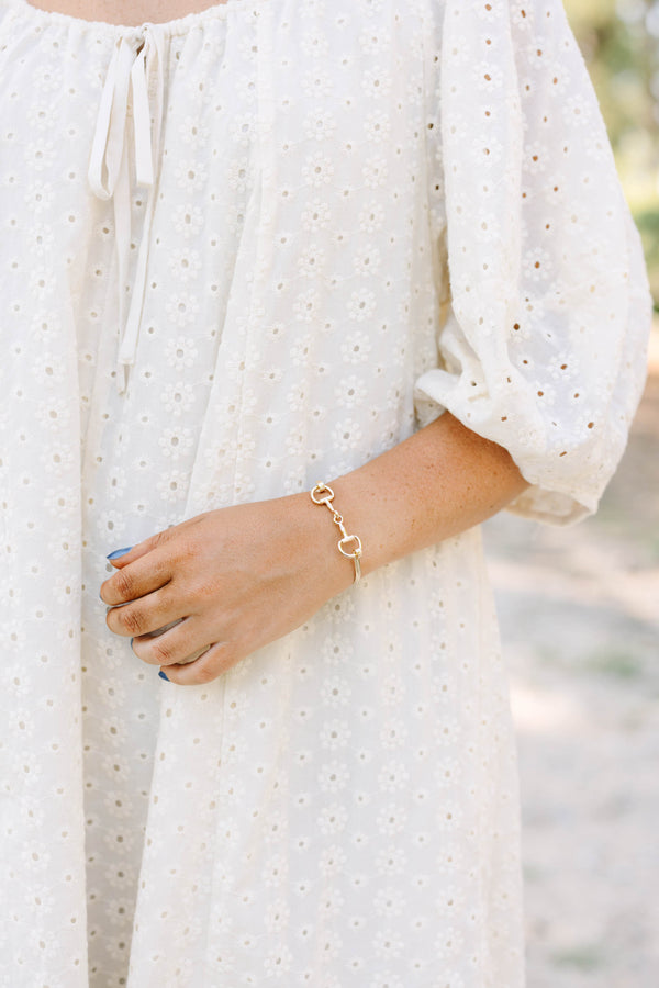 Plus Size gold horse bit style bangle bracelet worn with a white eyelet lace top.