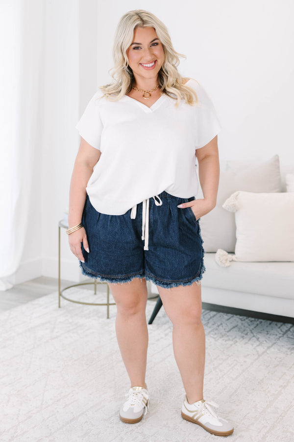 Plus size dark wash denim shorts with a drawstring elastic waist and frayed hem for a flowy fit.