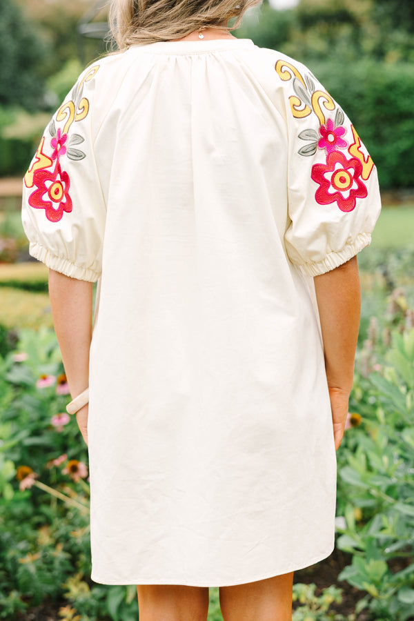 Plus Size cream cotton dress with a V-neckline and puff sleeves featuring colorful floral embroidery.