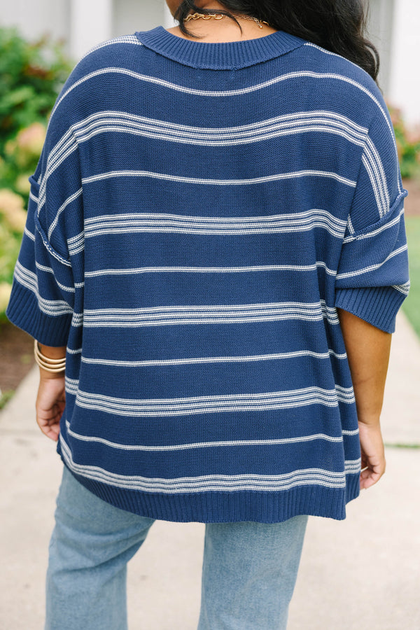 Plus size navy and white striped sweater with a flowy fit, crew neck, and elbow-length sleeves.