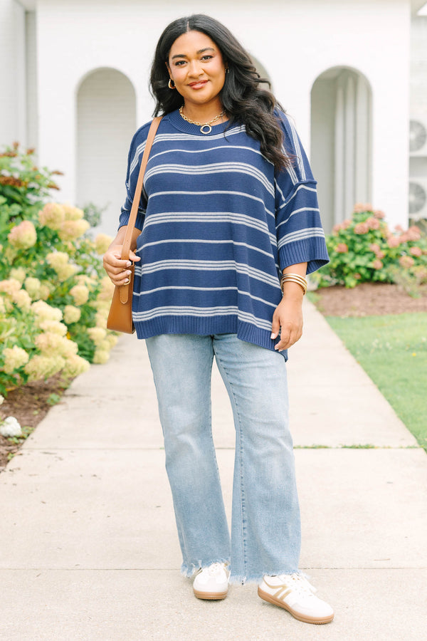 Plus size navy and white striped sweater with a flowy fit, crew neck, and elbow-length sleeves.
