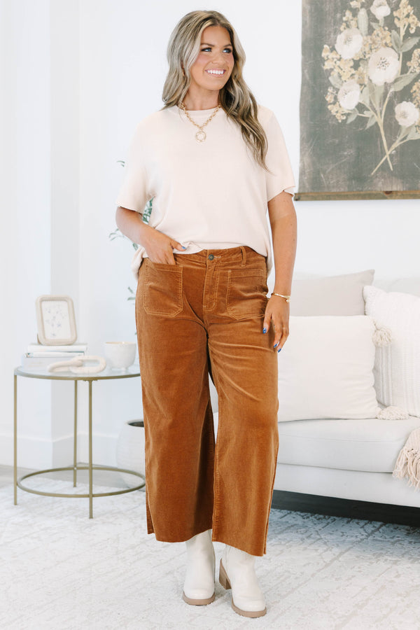 Plus Size brown corduroy wide-leg pants with front patch pockets and a raw hem.