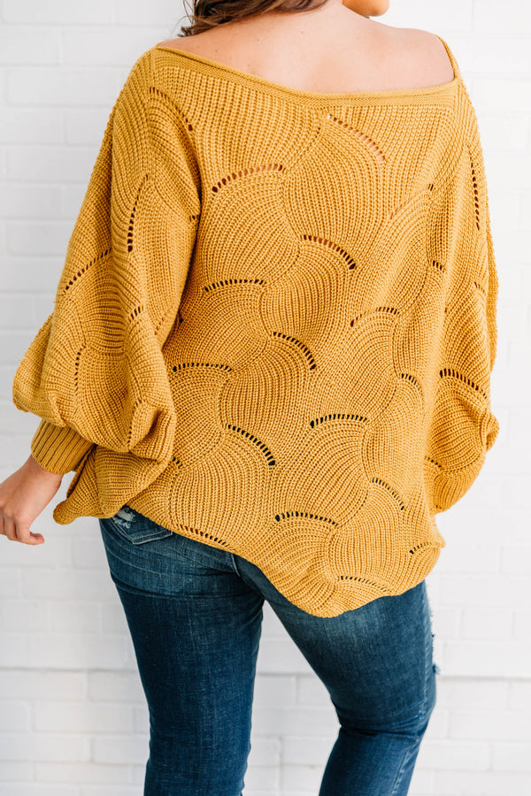 Plus Size mustard yellow poncho-style sweater with a textured wave pattern and dark wash jeans.