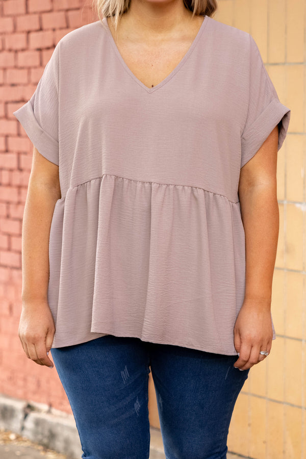 Plus Size toast-colored babydoll top with a V-neckline, cuffed short sleeves, and a tiered hem.