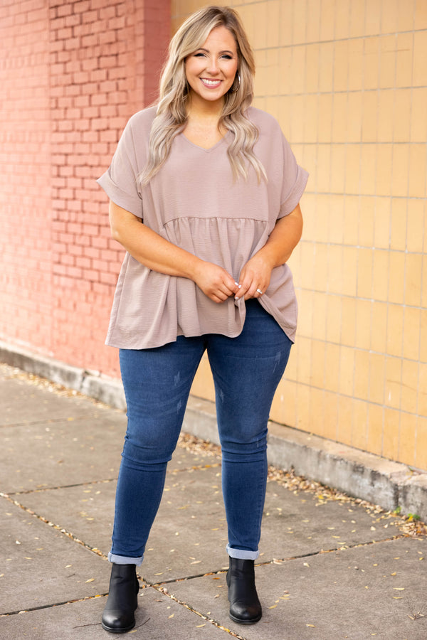 Plus Size toast-colored babydoll top with a V-neckline, cuffed short sleeves, and a tiered hem.