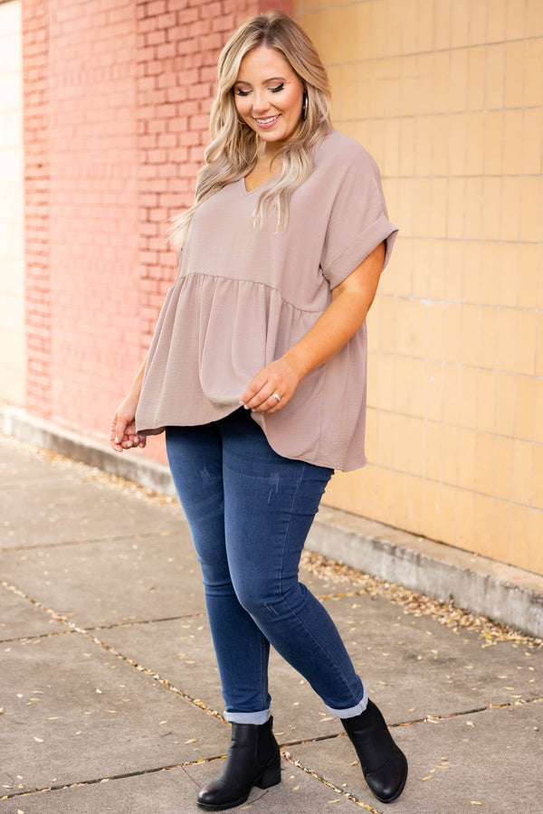 Plus Size toast-colored babydoll top with a V-neckline, cuffed short sleeves, and a tiered hem.