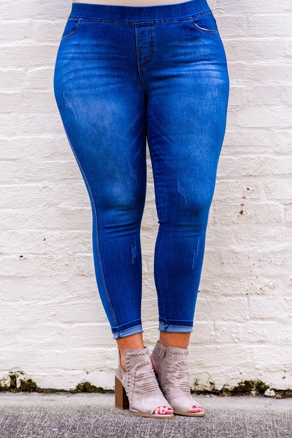 Plus Size medium wash jeggings with a stretchy high-rise waistband and distressed details.