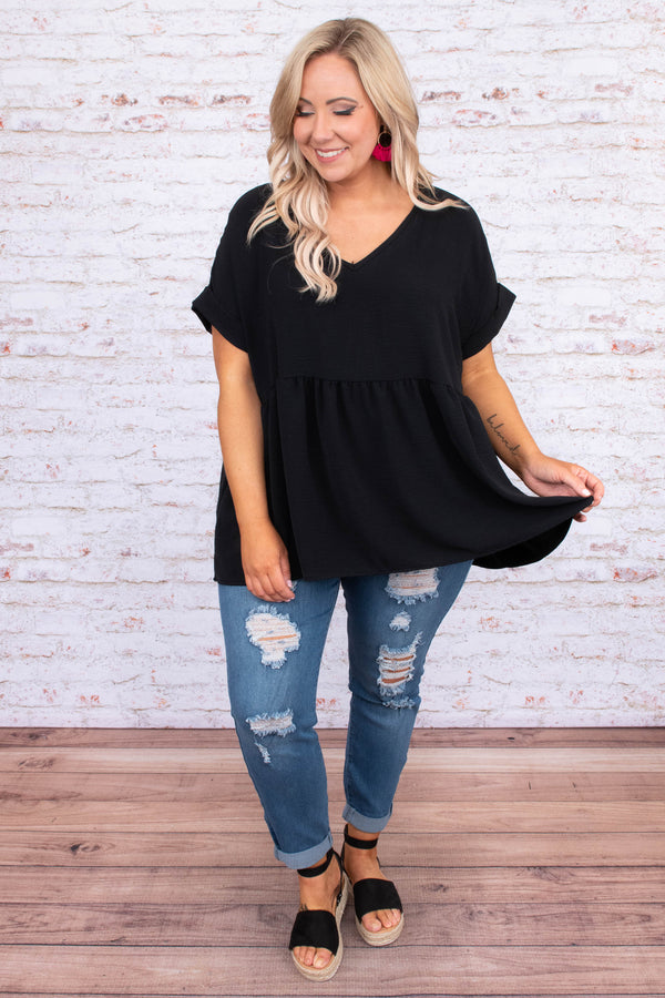 Plus Size black babydoll top with a v-neckline, cuffed short sleeves, and a flowy tiered hem.