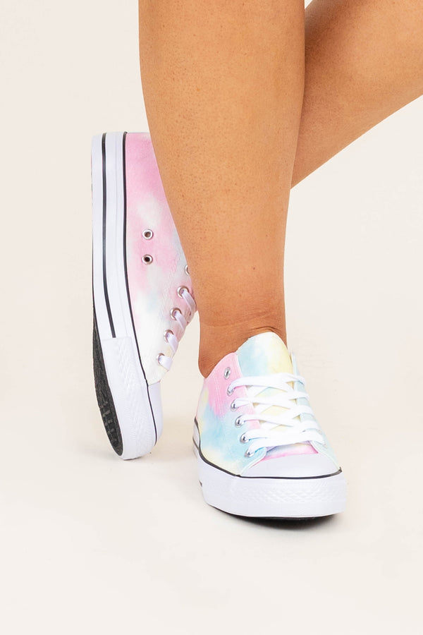 Plus Size tie dye low-top sneakers in pastel pink, blue, and yellow with white laces.