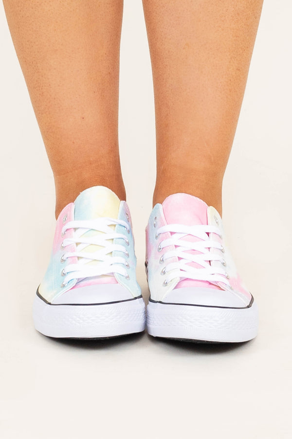 Plus Size tie dye low-top sneakers in pastel pink, blue, and yellow with white laces.