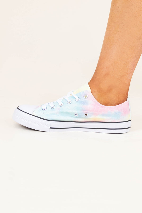 Plus Size tie dye low-top sneakers in pastel pink, blue, and yellow with white laces.