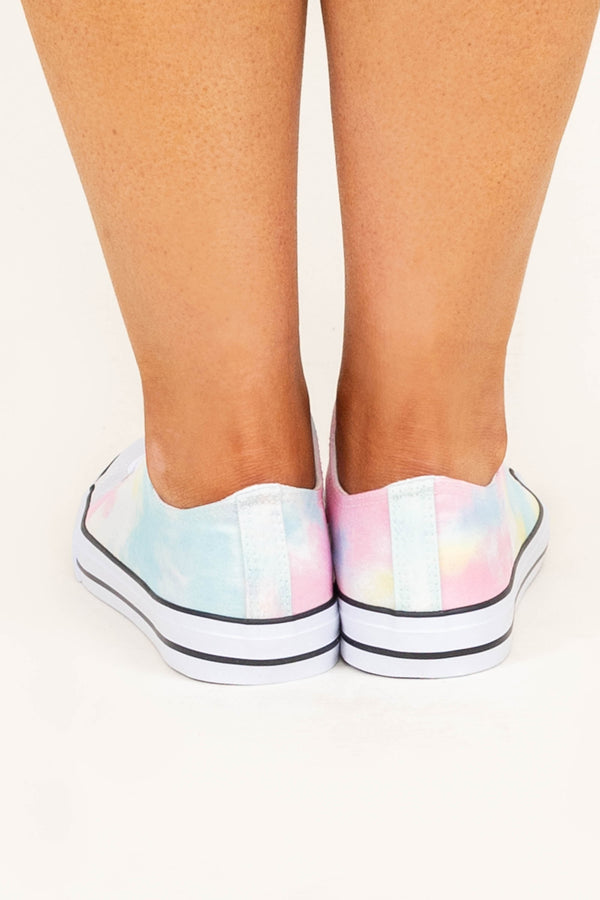 Plus Size tie dye low-top sneakers in pastel pink, blue, and yellow with white laces.