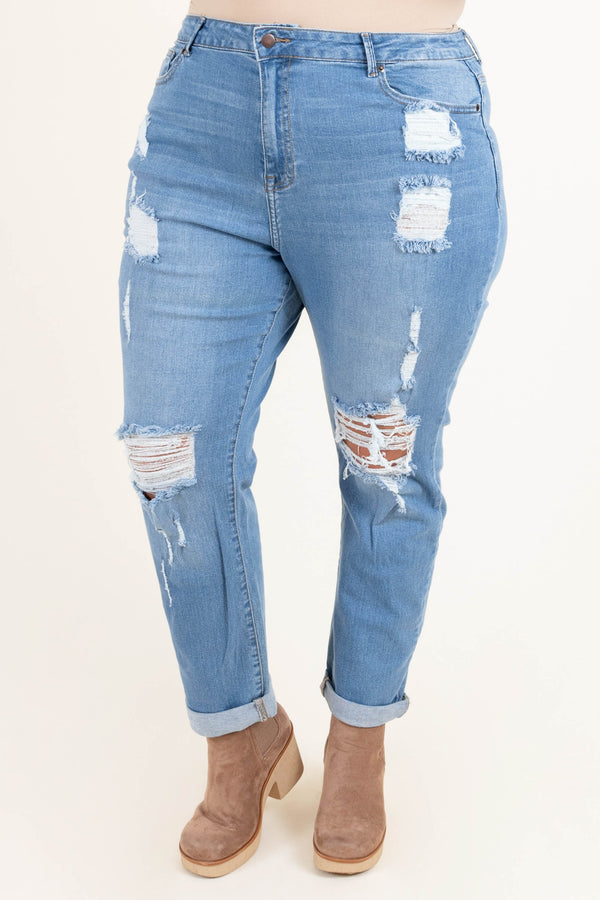 Plus Size light blue distressed jeans with a stretchy fit and cuffed hems.