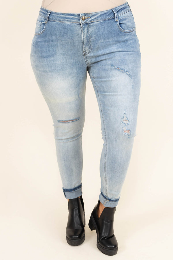 Chic Soul plus size clothing, mid-waisted light-wash denim slim-fitting jeans with light distressed detailing on the legs