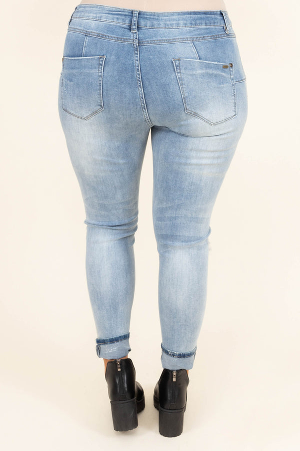 Chic Soul plus size clothing, mid-waisted light-wash denim slim-fitting jeans with light distressed detailing on the legs