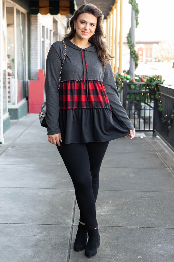 Chic Soul plus size clothing long sleeve top with a hoodie. The upper section of the shirt is in a dark gray color, the middle stripe is black and red plaid, and the lower portion is in a black color.